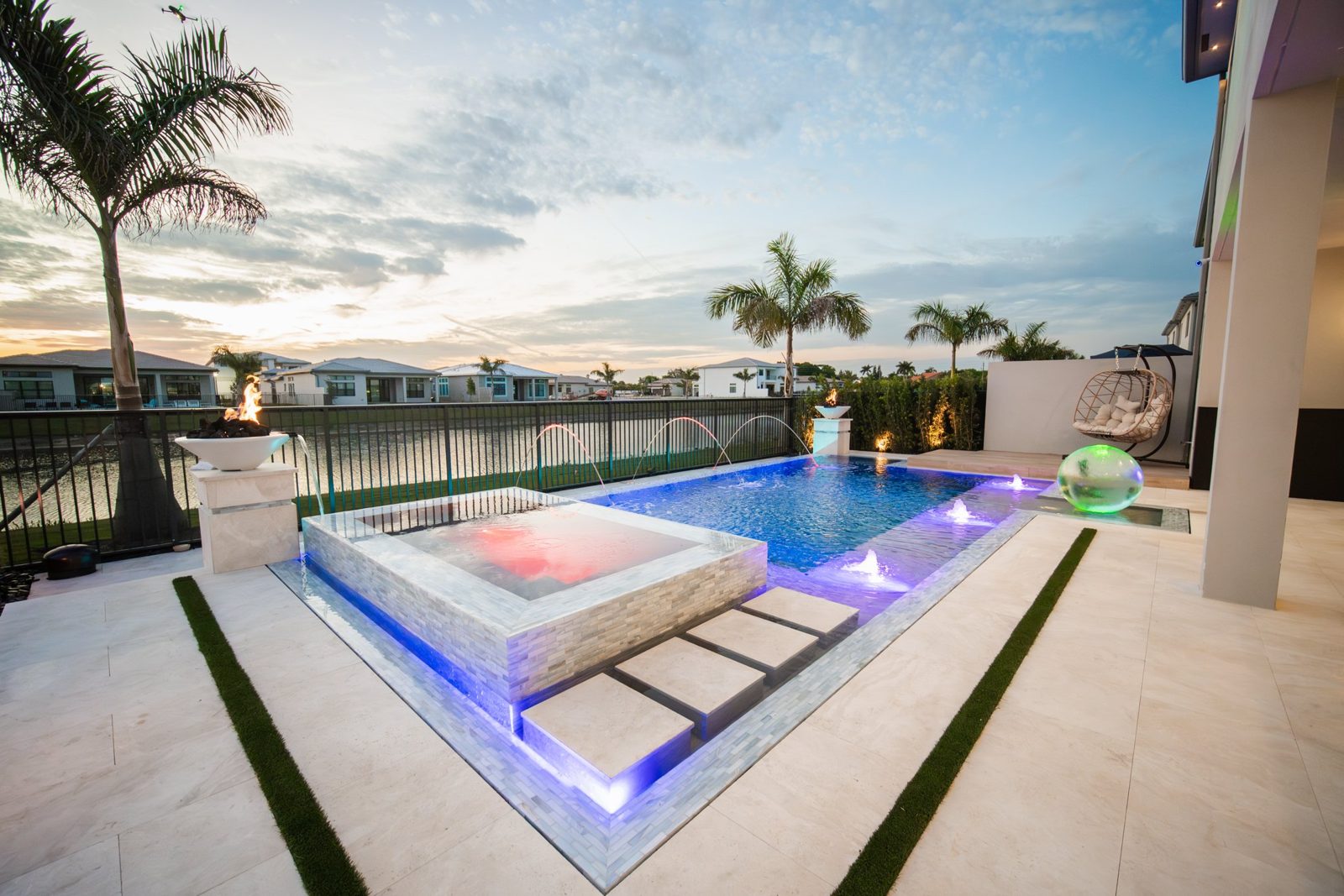 A finished Liquid Luxe custom pool and spa at dusk